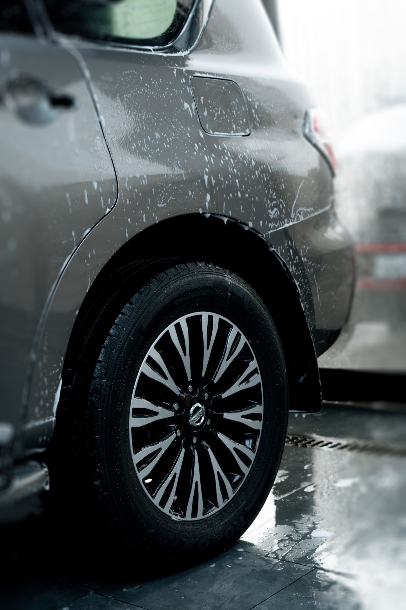 Alloy wheel and silver paint covered in water droplets after a rinse